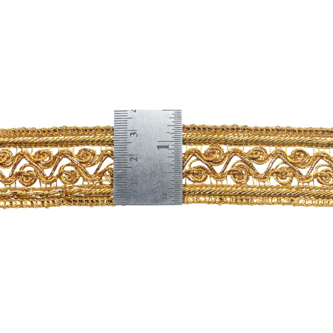 Gold decorative trim with a ruler for scale on a white background